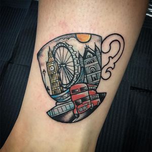 Colorful new school forearm tattoo featuring a cup and ferris wheel design by Matthew Ono. Playful and eye-catching!