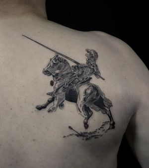 Get a stunning black and gray tattoo of a knight riding a horse on your upper back by Luca Salzano. Perfect for anyone who loves medieval themes.