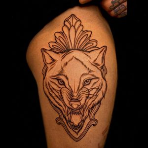 Experience the beauty of fine line realism with this stunning wolf and pattern tattoo by Edyta on your upper leg.