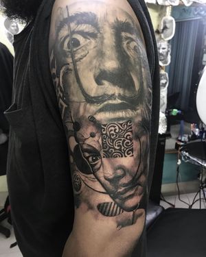 Get mesmerized by a black and gray illustrative pattern tattoo inspired by Salvador Dali's surrealism, expertly done by Avi on your upper arm.
