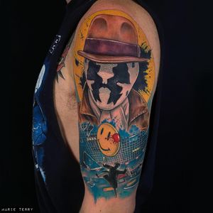 Get inked with a vibrant anime-style tattoo of a man wearing a hat on your upper arm by tattoo artist Marie Terry.