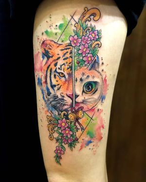 Capture the beauty of nature with this watercolor design featuring a fierce tiger, delicate cherry blossoms, and intricate filigree details. By tattoo artist Avi.