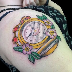 Check out this vibrant new school tattoo featuring a beautiful flower and intricate clock design, inked by Letitia Mortimer.
