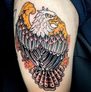 Get a striking eagle tattoo on your upper arm with bold colors and strong lines by the talented artist Matthew Ono.