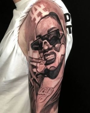 Capture the essence of elegance with this black and gray upper arm tattoo featuring a woman wearing glasses. Expertly done by Mauro Imperatori.