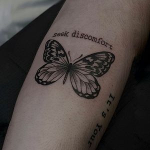 Beautiful black and gray butterfly design with small lettering quote on forearm by Luca Salzano.