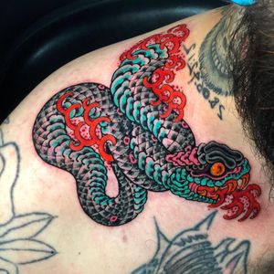 Experience the intricate beauty of a Japanese snake tattoo on your shoulder by the talented artist Matthew Ono.