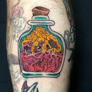 Vibrant new school lower leg tattoo featuring a skull and bottle, done by the talented artist Matthew Ono.
