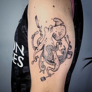 Vibrant new school design on upper arm by Jonathan Glick featuring a playful octopus in a kitchen setting.