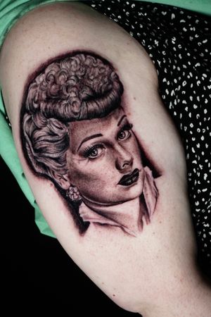 Get inked with a stunning blackwork realistic woman portrait adorning earrings on your upper arm, by the talented Miss Vampira.