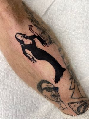 Blackwork illustration of a haunting woman on the shin, by Miss Vampira. Perfect for fans of horror and dark art.