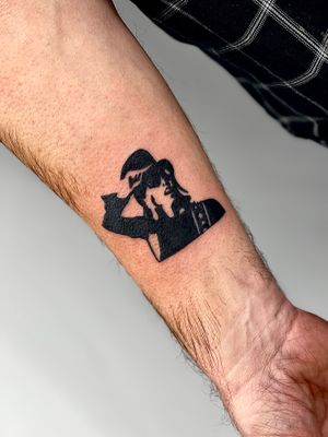 Unique illustrative tattoo featuring a man and woman in hats, done by the talented artist Miss Vampira.