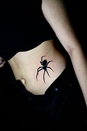 Explore the dark allure of this stunning blackwork spider tattoo designed by the talented artist Miss Vampira. Perfect for rib placement.