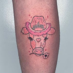 Ignorant style tattoo by Galen Bryce featuring a cow, flower, and hat on lower leg.