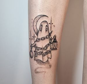 A vibrant new school tattoo by Jonathan Glick featuring a ghostly figure tangled in chains on the forearm.