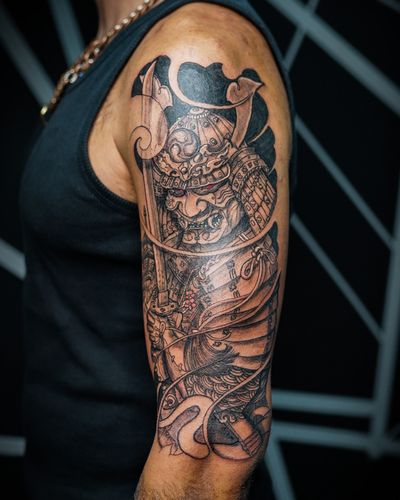 Immerse yourself in the world of Japanese culture with this striking tattoo featuring a samurai and katana, meticulously designed by Soheyl Astangi.