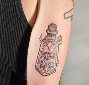 Vibrant new school design on upper arm by Jonathan Glick. Get lost in this whimsical fusion of a funky bottle and enchanting mushroom.