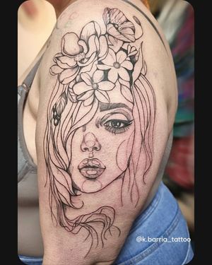 Beautiful neo traditional upper arm tattoo featuring a stunning woman intertwined with intricate flowers, expertly done by Katia Barria.