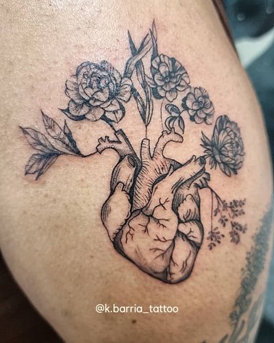 Beautifully designed tattoo by Katia Barria featuring a vibrant flower and heart motif on the shoulder. Perfect for a unique and meaningful tattoo statement.