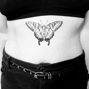 Graceful fine line butterfly tattoo on the stomach by Katia Barria. Delicately intricate and beautifully designed.