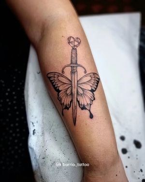 Intricate black and gray fine line design featuring a butterfly and dagger, masterfully done by artist Katia Barria.