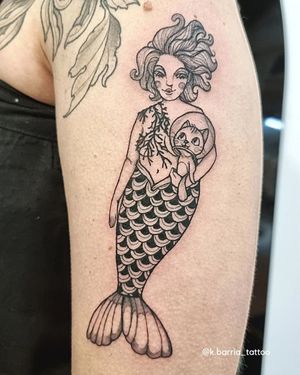 Get a stunning black and gray tattoo of a creative combination of a cat and mermaid by the talented artist Katia Barria.