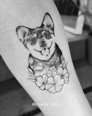 Stunning black and gray micro-realism forearm tattoo by Katia Barria capturing a lifelike dog portrait surrounded by delicate flowers.