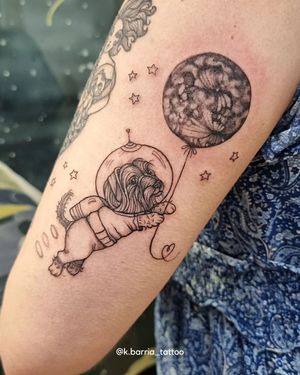 Capture the bond between a fearless astronaut and their loyal companion with this stunning black and gray fine line tattoo by Katia Barria.