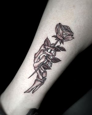 Skeleton hand with rose.