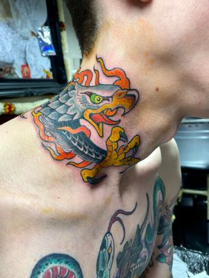 Get a stunning neo traditional eagle tattoo on your neck by the talented artist Adam Ruff. Bold lines and vibrant colors will make this piece stand out.