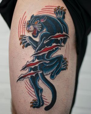 Get fierce with this neo traditional panther tattoo on your upper arm, expertly done by tattoo artist Adam Ruff.