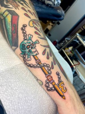 Vibrant and detailed new school design by Adam Ruff featuring a skull and key on the forearm.