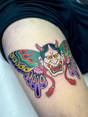 Vibrant fusion of traditional and modern styles by tattoo artist Adam Ruff. A unique design featuring a beautiful butterfly and fierce hannya mask on the upper leg.
