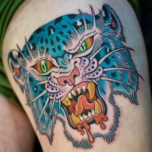 Get inked with a fierce tiger design by tattoo artist Adam Ruff. Bold colors and intricate details make this piece stand out.