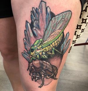 Experience the beauty of nature with this unique upper leg tattoo featuring a crystal, cricket, and bug, expertly done by Gifford Kasen.