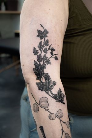 Check out this stunning blackwork flower tattoo on the arm, expertly executed by the talented artist Gifford Kasen!