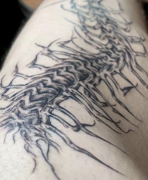 Black and gray patterned centipede tattoo by José on the shoulder. Unique and detailed design.
