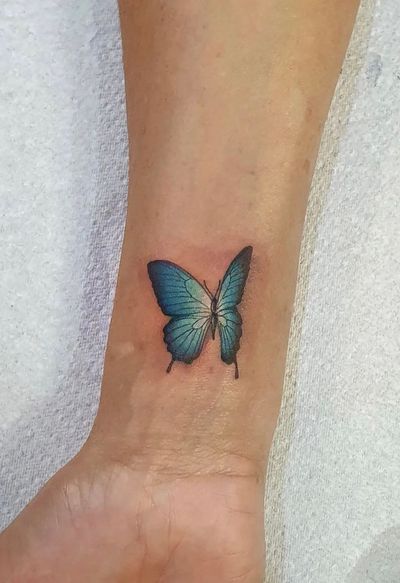 Color butterfly as a lady’s first tattoo