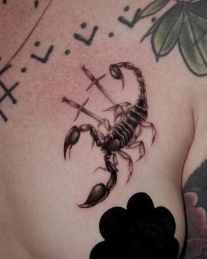Experience the power of the scorpion and sword in this stunning black and gray chest tattoo by Alexander Rufio.