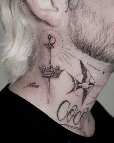 Experience the detailed beauty of micro-realism with this stunning sword and crown tattoo by Alexander Rufio.