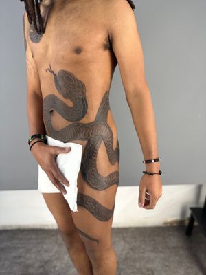 Experience the mystical allure of a Japanese snake tattoo on your upper leg by renowned artist Hansol Jung.