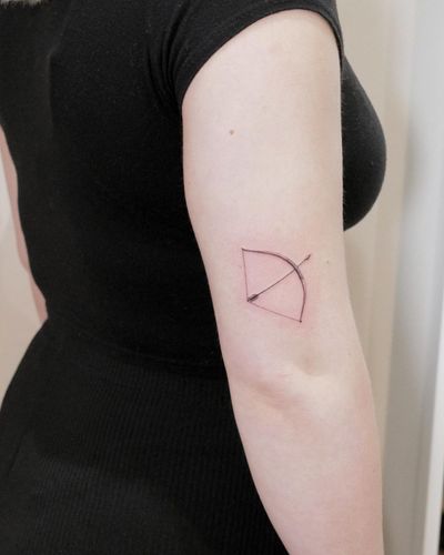 Get a stunning micro-realism tattoo of an arrow and bow on your upper arm, expertly done by the talented artist Alexander Rufio.
