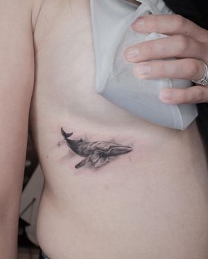 Experience the beauty of the ocean with this stunning micro-realism whale tattoo, expertly done by artist Alexander Rufio.