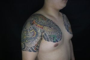 Unique Japanese chest tattoo featuring a mystical snake and Hannya mask design, expertly crafted by tattoo artist Hansol Jung.