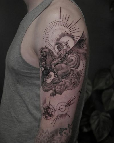 Black and grey upper arm tattoo featuring a unique geometric design of a dragon and Saint George, executed by the talented artist Alexander Rufio.