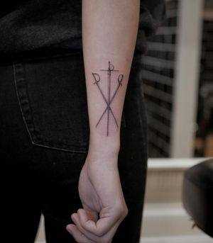 Elegant black and gray micro-realism sword design on forearm. Expertly crafted by the talented artist Alexander Rufio.