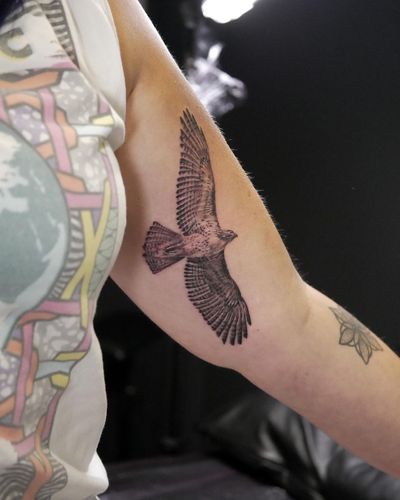 Get a stunning black and gray eagle tattoo on your upper arm by the talented artist Alexander Rufio.
