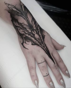 Get a stunning black and gray pattern tattoo on your hand by the talented artist Rachel Aspe at Bellatrix Tattoo.