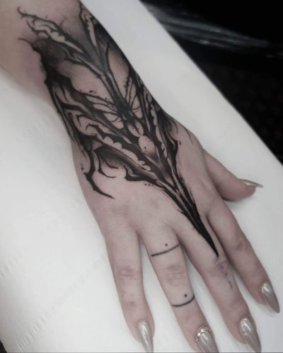 Get a stunning black and gray pattern tattoo on your hand by the talented artist Rachel Aspe at Bellatrix Tattoo.