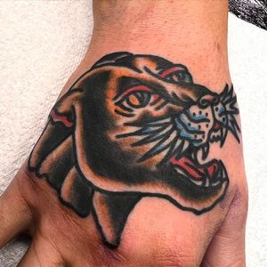 Get fierce with this traditional panther tattoo by Alessandro Lanzafame, perfect for your hand placement.